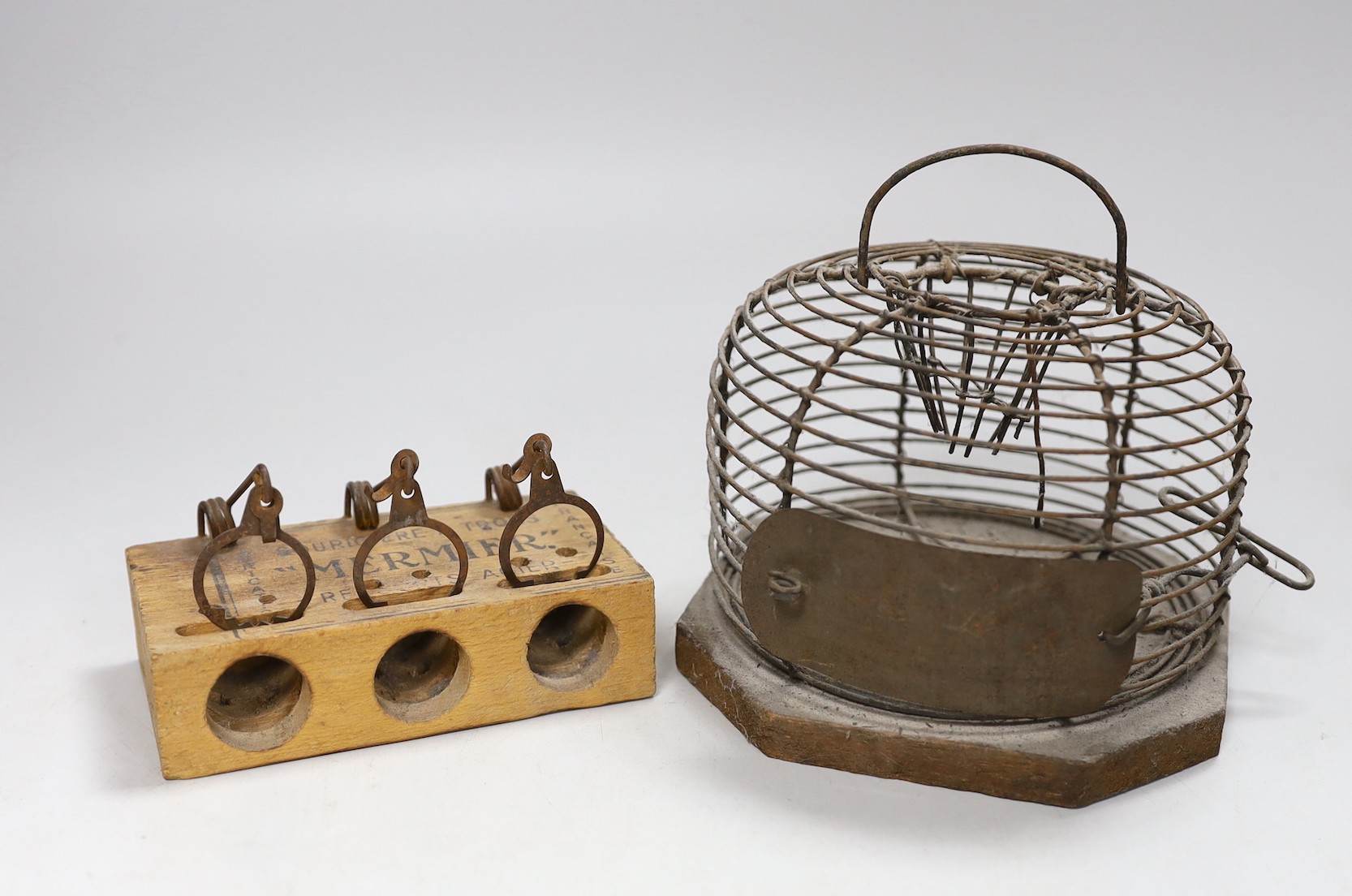 A circular metal mouse trap and a Mermier mouse trap